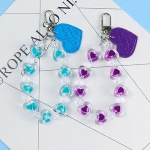 Detail of blue and purple beaded heart keychains with silver rotating metal clasps