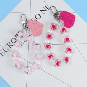 Detailed view of pink and red heart bead keychains with lovely home leather tags