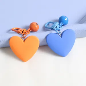 Cute heart-shaped bell keychain with orange and blue matte finish for bags and cars