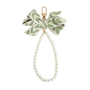 Elegant green leaf ribbon bow keychain with pearls and gold metal spring clasp decor