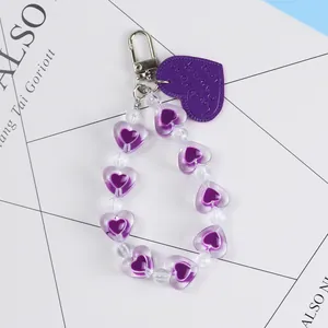 Detailed view of purple heart beaded keychain with Lovely Home embossed charm