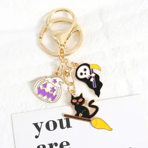 Halloween keychain with Grim Reaper, pumpkin and black cat charms in gold alloy