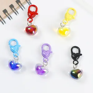 Detail showing five colorful jelly heart pendants with iridescent lobster clasps on white