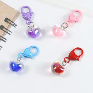 Flat lay of four colorful translucent resin heart pendants with aurora polar effect