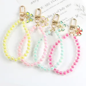 Beaded butterfly charm keychains in assorted pastel colors with golden metal lobster clasps