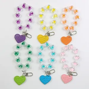Colorful heart-shaped beaded keychains with metal lobster clasps and engraved pendants