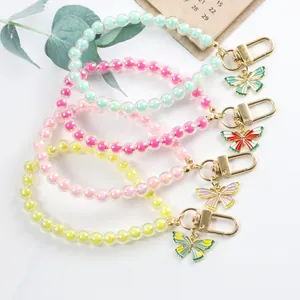Colorful beaded wristlet keychains with enamel butterfly charms in multiple pastel colors