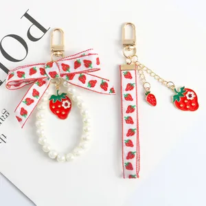 Cute strawberry pearl keychain with ribbon bow and fruit pendants for bags or AirPods