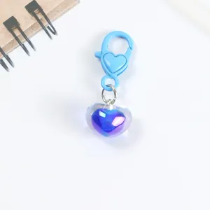 Detail of blue heart pendant with faceted resin texture and matching lobster clasp