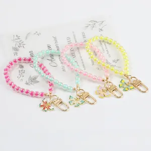 Detail of colorful acrylic beaded keychains with metal clasps and butterfly charms