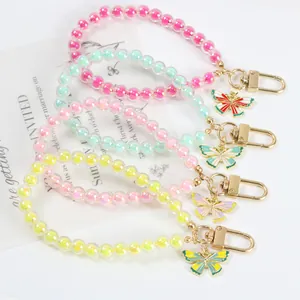 Detailed display of colorful beaded butterfly keychains with gold lobster clasps
