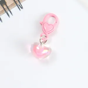 Macro shot of pink aurora heart pendant keychain with shimmering iridescent finish