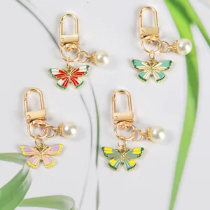 Butterfly and pearl keychain set with gold lobster clasp for bags and Airpods