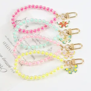 Detailed view of colorful acrylic beaded keychains with butterfly charms in four colors