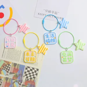 Flat lay of colorful acrylic square charms with star pendants on steel wire rings