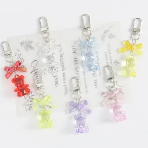 Colorful crystal bear keychains with iridescent bows in seven vibrant translucent colors