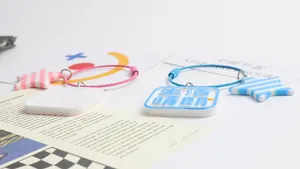 Close-up of pastel star pendants and square charms on colorful wire loop keychains