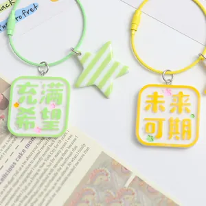 Cute candy-colored square keychain with star charm and inspirational script on cable ring