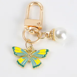 Elegant butterfly and pearl keychain with gold-tone lobster clasp for bags and accessories