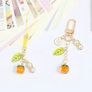 Creative persimmon and peanut keychain pendant symbolic of good luck and prosperity