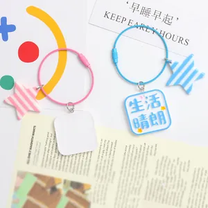 Detail of candy-colored wire keychains with star charms and square acrylic pendants