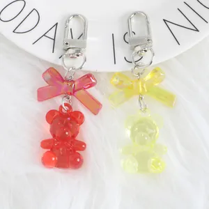 Macro view of colorful crystal bear keychains with laser bowknot on a white ceramic plate