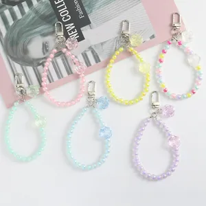 Detailed view of colorful crystal flower beaded keychains with metal lobster clasps