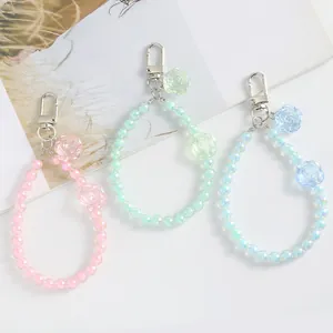 Macro shot of colorful aurora crystal bead keychains with rose flower charms and silver clasp