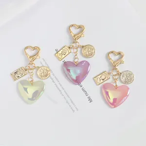 Detail of glitter heart charms in pink, purple, and green with vintage gold pendants