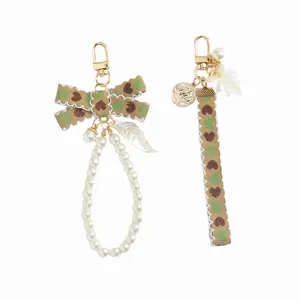 Portachiavi con fiocco e perle sintetiche per decorazione di borse e accessori