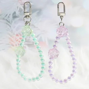 Detail of aurora crystal flower keychains with iridescent beads and silver lobster clasps