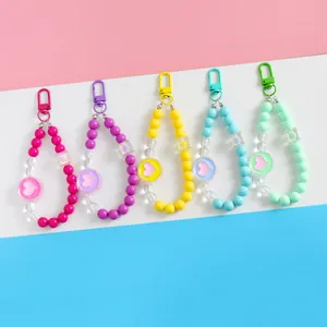 Close-up of five colorful acrylic heart beaded phone charms with metal lobster clasps