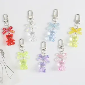 Detailed collection of seven colorful resin bear charms with metal bow keychains