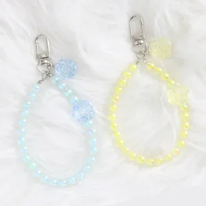 Close-up of colorful crystal flower bead charms with shiny finish and silver metal clasps
