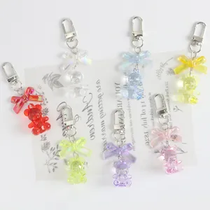 Close-up of colorful resin bear keychains with iridescent bows and lobster clasps
