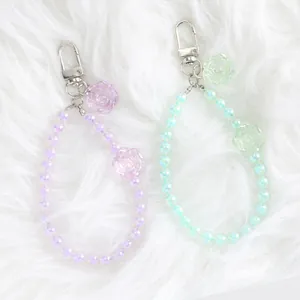 Close-up of colorful crystal flower bead keychains with iridescent luster and silver clasp