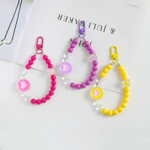 Detailed view of colorful heart-shaped acrylic bead phone charms and lobster clasps