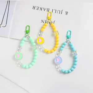 Detailed close-up of colorful heart acrylic beaded keychains in green, yellow and blue