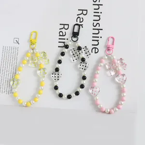 Set portachiavi e ciondoli per telefono con perle e cuori nei colori giallo, nero e rosa