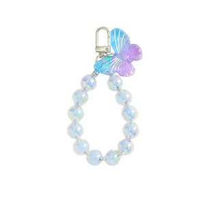 Charm con perline iridescenti, farfalla sfumata e perle rotonde effetto aurora