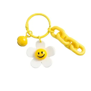 Porte-clés fleur souriante en acrylique jaune avec clochette et chaînette décorative