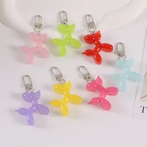 Set of seven colorful jelly balloon dog keychains with silver lobster clasps on white
