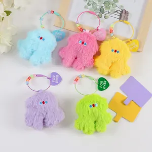 Detail of colorful plush pendants with heart tags and steel wire rings for bags