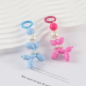 Detail of pink and blue balloon dog keychains with faux pearls and metal ring