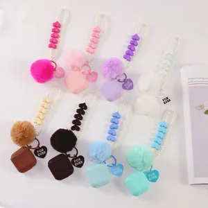 Variety of silicone earphone cases with heart pearl chains and soft fur pompom details