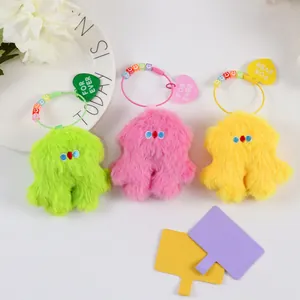Three plush colorful monster keychains with vibrant fur and heart forever pendants