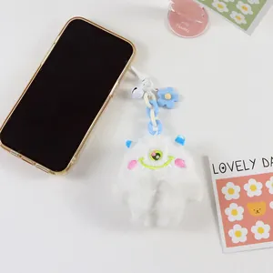 Cute white plush monster keychain with green single eye and blue flower charm accessory