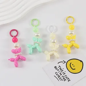 Detail of colorful balloon dog keychains with faux pearl accents in four vibrant colors