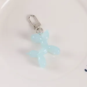 Close-up of a light blue jelly balloon dog keychain with silver metal lobster clasp