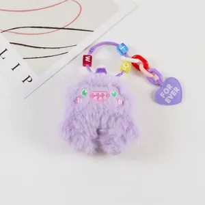 Close-up of purple plush monster charm with letter beads and a heart for ever pendant